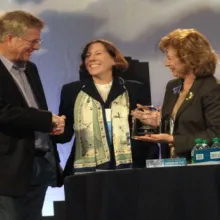 Lisa Adeli receives award from Rick Steves.