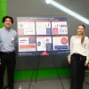 Four students stand around a presentation board titled "what drives employment success?"