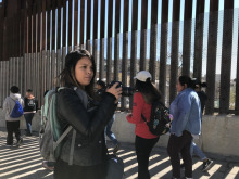 Carmen Valencia, a former journalism undergraduate student, gets ready to take a photograph during a tour of Ambos Nogales.