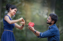 man handing red plastic heart to woman