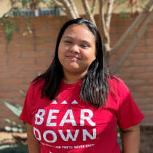 girl with brown hair in red bear down shirt
