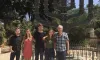 Professor and four students stand in front of a large Menorah, outside the Knesset in Jerusalem